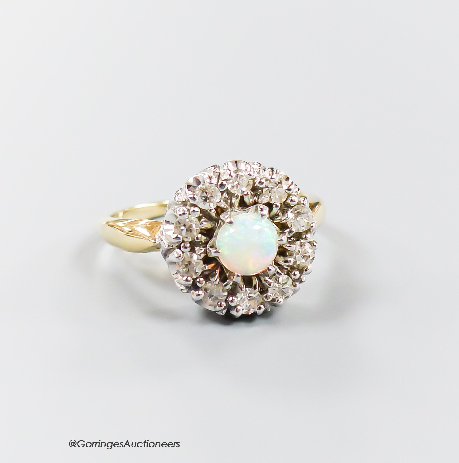 A modern 14k, white opal and illusion set diamond circular cluster ring, size L, gross 4.7 grams.
